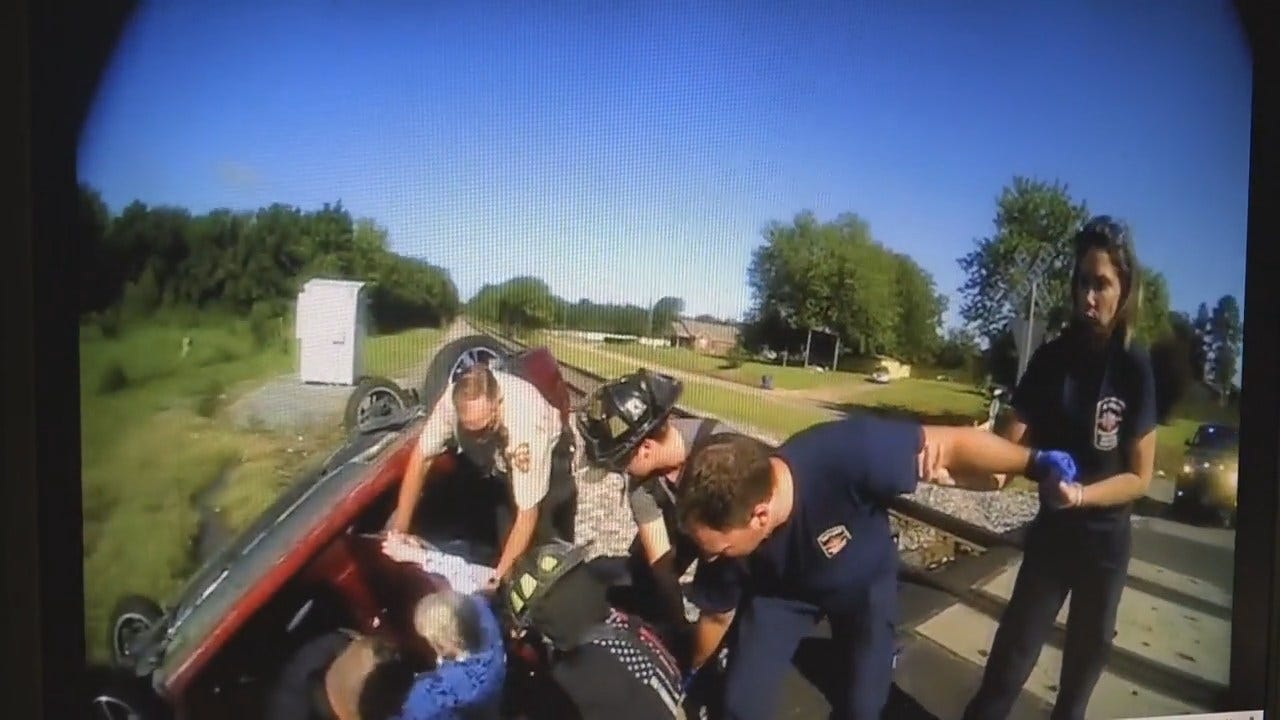 WATCH Train Barely Misses Muldrow Woman Trapped In Wrecked Car