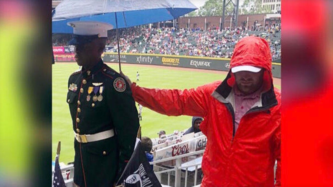 Powerful Image Shows Braves Fan Holding Umbrella For Marine Corps JROTC